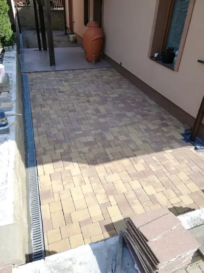 Dlažba podél domu s odvodňovacím žlabem