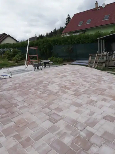 Velká terasa ze světle cihlové dlažby na zahradě